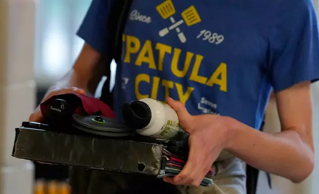 A student walks through a secure entrance at Midtown High School, Friday, March 6, 2026, in Atlanta. (AP Photo/Mike Stewart)