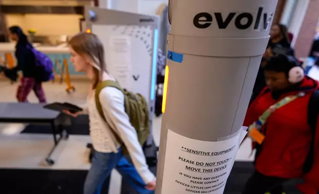 Students enter a security checkpoint at Midtown High School, Friday, March 6, 2026, in Atlanta. (AP Photo/Mike Stewart)
