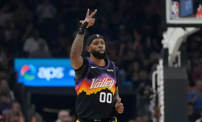 Phoenix Suns forward Royce O'Neale celebrates a 3-pointer against the Utah Jazz during the first half of an NBA basketball game, Saturday, March 28, 2026, in Phoenix. (AP Photo/Ross D. Franklin)