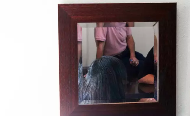 Palestinians who traveled to South Africa via a charter flight organized by an Israeli group whose founder supported U.S. President Donald Trump's proposal to resettle Palestinians from Gaza stand in their temporary flat in Johannesburg, South Africa, Wednesday, Feb. 4, 2026.(AP Photo/Jerome Delay)