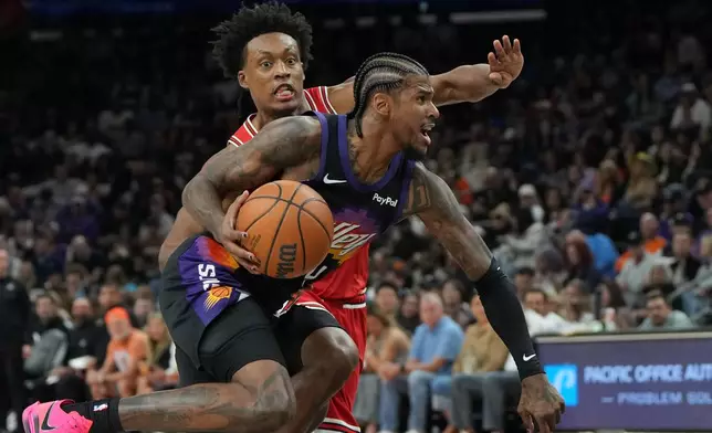 Phoenix Suns guard Jalen Green (4) drives past Chicago Bulls guard Collin Sexton during the first half of an NBA basketball game, Thursday, March 5, 2026, in Phoenix. (AP Photo/Rick Scuteri)