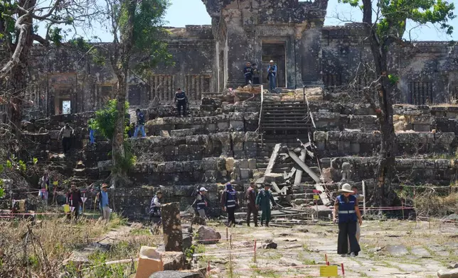 Journalists visit the Preah Vihear temple, damaged during border clashes with Thailand, at Preah Vihear province, Cambodia, Saturday, March 14, 2026. (AP Photo/Heng Sinith)
