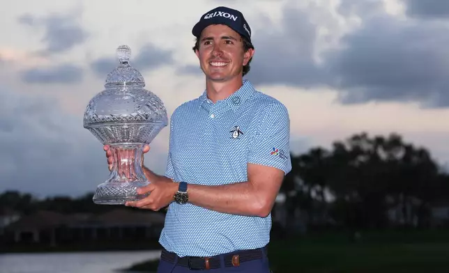 Nico Echavarria of Colombia holds the Cognizant Classic Trophy at the end of the final round of the Cognizant Classic golf tournament, Sunday, March 1, 2026, in Palm Beach Gardens, Fla. (AP Photo/Marta Lavandier)