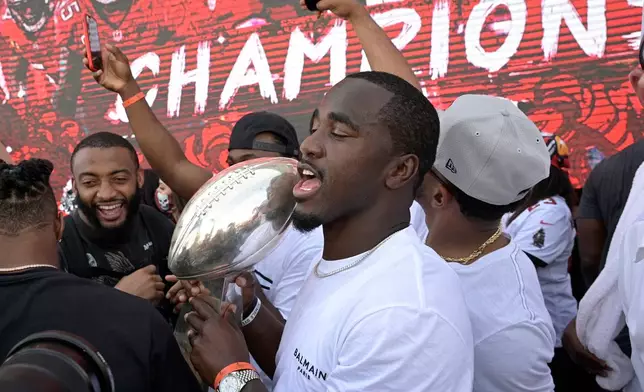 FILE - Tampa Bay Buccaneers linebacker Lavonte David holds the Vince Lombardi Trophy during a celebration of the team's Super Bowl 55 victory over the Kansas City Chiefs, Feb. 10, 2021, in Tampa, Fla. (AP Photo/Phelan M. Ebenhack, File)