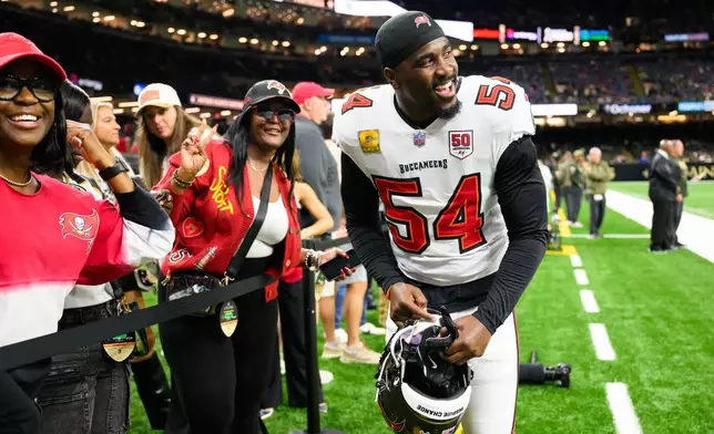 FILE - Tampa Bay Buccaneers linebacker Lavonte David (54) with his family before an NFL football game against the New Orleans Saints, Oct. 26, 2025, in New Orleans. (AP Photo/Ella Hall, File)