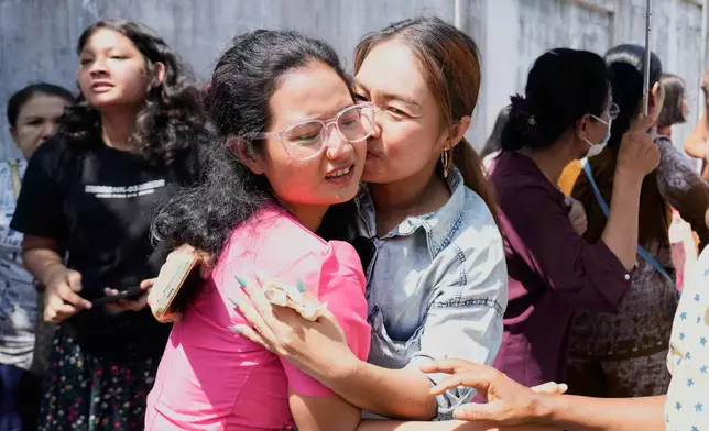 A released prisoner, front left, is welcomed by her colleagues after she was released from Insein Prison Monday, March 2, 2026, in Yangon, Myanmar. (AP Photo/Thein Zaw)