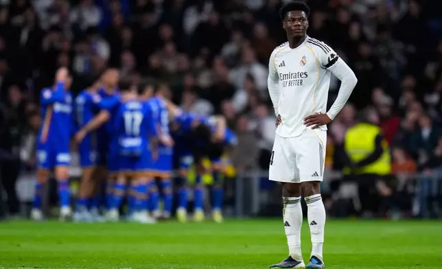 Real Madrid's Aurelien Tchouameni stands as Getafe's Satriano celebrates with team mates the opening goal during a Spanish La Liga soccer match between Real Madrid and Getafe in Madrid, Spain, Monday, March 2, 2026. (AP Photo/Manu Fernandez)