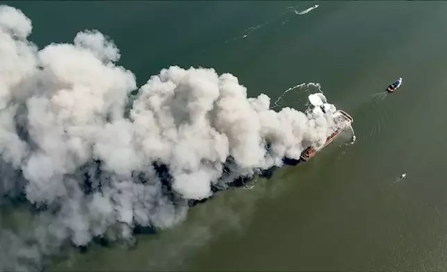 Smoke fills the sky as firefighters battle a massive blaze that erupted on a barge on the Delaware River on Tuesday, March 10, 2026 in New Castle, Del. (WPVI via AP)