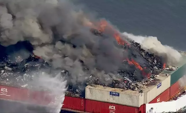 Smoke fills the sky as firefighters battle a massive blaze that erupted on a barge on the Delaware River on Tuesday, March 10, 2026 in New Castle, Del. (WPVI via AP)