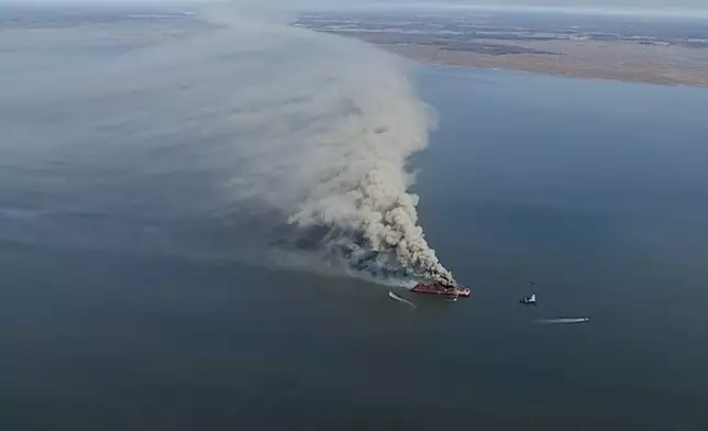 Smoke fills the sky as firefighters battle a massive blaze that erupted on a barge on the Delaware River on Tuesday, March 10, 2026 in New Castle, Del. (WPVI via AP)