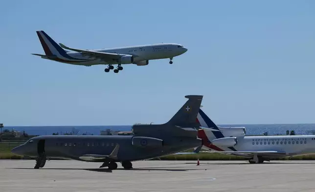 The aircraft transporting French President Emmanuel Macron lands ahead of his meeting with Greece's Prime Minister Kyriakos Mitsotakis and Cyprus President Nikos Christodoulides at Andreas Papandreou Air Base in Paphos, Cyprus, on Monday, March 9, 2026. (AP Photo/Petros Karadjias)