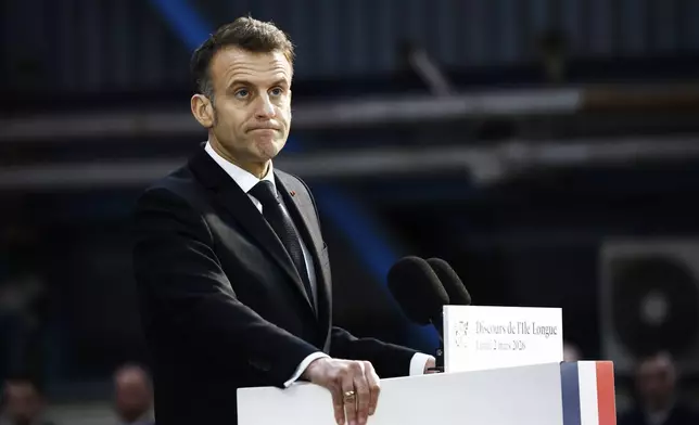 French President Emmanuel Macron delivers a speech next to the submarine 'Le Temeraire' (The Temerarious) at the Nuclear submarines Navy base of Ile Longue in Crozon, France, Monday March 2, 2026. (Yoan Valat/Pool Photo via AP)