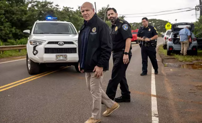 Honolulu Mayor Rick Blangiardi surveys flood damages in Haleiwa, Hawaii Saturday, March 21, 2026. (Stephen Lam/San Francisco Chronicle via AP)