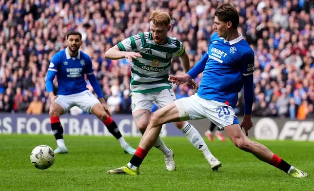 Celtic's Liam Scales and Rangers' Ryan Naderi, right, in action during the Scottish Cup quarterfinal soccer match between Rangers and Celtic, in Glasgow, Scotland, Sunday March 8, 2026. (Andrew Milligan/PA via AP)