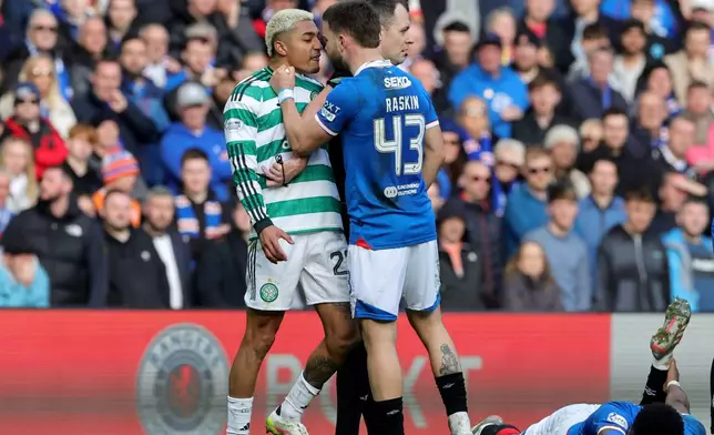 Celtic's Julian Araujo, center left and Rangers' Nicolas Raskin clash, during the Scottish Cup quarterfinal soccer match between Rangers and Celtic, in Glasgow, Scotland, Sunday March 8, 2026. (Steve Welsh/PA via AP)