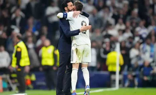 Real Madrid's head coach Alvaro Arbeloa hugs Federico Valverde after he scored during a first leg round of 16 Champions League soccer match between Real Madrid and Manchester City in Madrid, Spain, Wednesday, March 11, 2026. (AP Photo/Jose Breton)