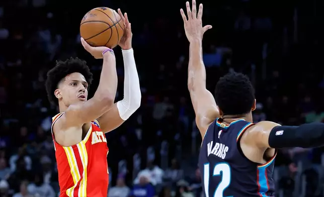 Atlanta Hawks forward Jalen Johnson (1) takes a shot against Detroit Pistons forward Tobias Harris (12) during the first half of an NBA basketball game Wednesday, March 25, 2026, in Detroit. (AP Photo/Duane Burleson)