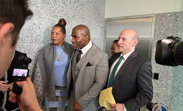 Kenneth Windley, center, speaks with reporters while accompanied by his fiancée, Donna Carter, left, and attorney David Shanies, right, outside of the courthouse in the Brooklyn borough of New York, Monday, March 16, 2026. (AP Photo/Jennifer Peltz)