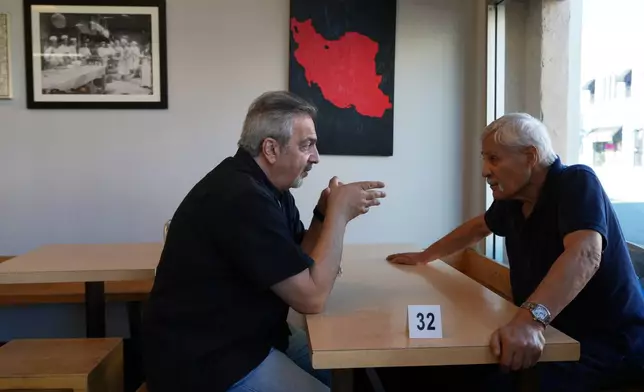 Customers talk inside the Taste of Tehran restaurant at the area known Little Tehran" or "Tehrangeles," the heart of the largest Iranian diaspora community in the United States, in Los Angeles, Monday, March 2, 2026. (AP Photo/Damian Dovarganes)