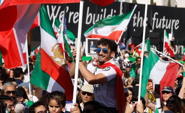 People chat slogans during a demonstration in support of the U.S. and Israeli strikes on Iran on Sunday, March 1, 2026, in Los Angeles. (AP Photo/Jill Connelly)