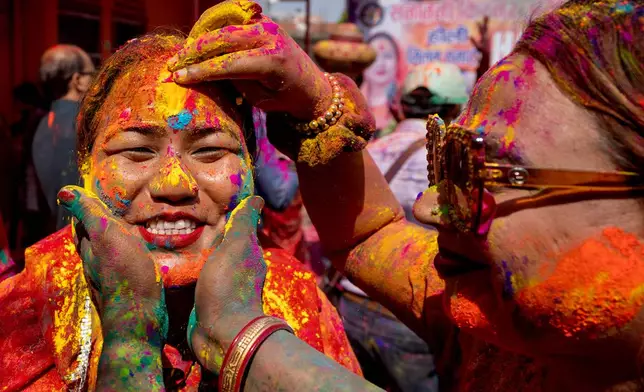 Third Gender members of Kinnar Akhara play with colored powder during celebrations marking Holi, the Hindu festival of colors, in Prayagraj, in the northern Indian state of Uttar Pradesh, India, Sunday, March 1, 2026. (AP Photo/Rajesh Kumar Singh)