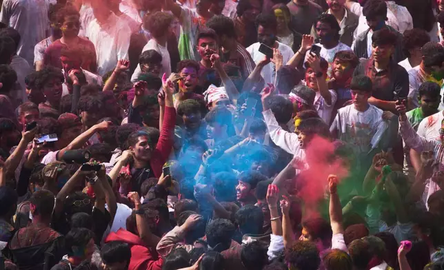 Nepalese people throw colored powders on each other as they celebrate Holi, the Hindu festival of colors at Basantapur Durbar Square in Kathmandu, Nepal, Monday, March 2, 2026. (AP Photo/Niranjan Shrestha)
