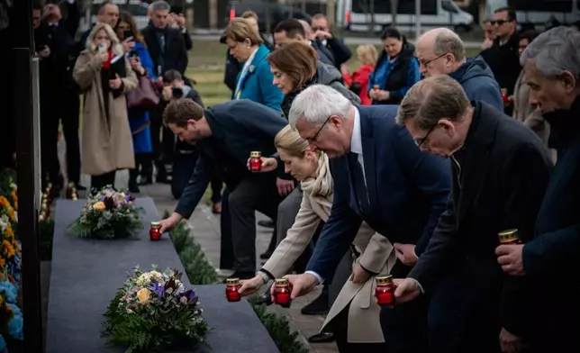 In this photo provided by the Ukrainian Foreign Ministry Press Office, High Representative of the European Union for Foreign Affairs and Security Policy Kaja Kallas, center left, Ukraine's Foreign Minister Andrii Sybiha, center right, and EU foreign ministers attend a commemorating ceremony in Bucha, Ukraine, Tuesday, March 31, 2026. (Ukrainian Foreign Ministry Press Office via AP)