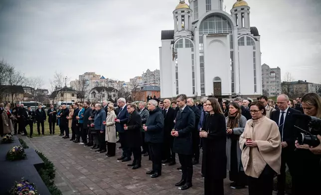 In this photo provided by the Ukrainian Foreign Ministry Press Office, High Representative of the European Union for Foreign Affairs and Security Policy Kaja Kallas, center left, Ukraine's Foreign Minister Andrii Sybiha, center right, and EU foreign ministers attend a commemorating ceremony in Bucha, Ukraine, Tuesday, March 31, 2026. (Ukrainian Foreign Ministry Press Office via AP)