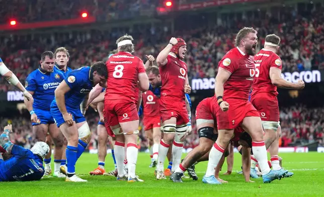 Wales players celebrate their side's third try of the game, scored by Dewi Lake, during the Men's Six Nations match between Wales and Italy in Cardiff, Wales, Saturday March 14, 2026. (David Davies/PA via AP)