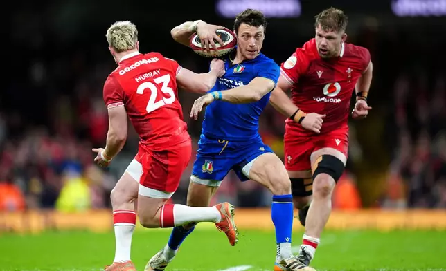 Italy's Paolo Garbisi evades Wales' Blair Murray during the Men's Six Nations match between Wales and Italy in Cardiff, Wales, Saturday March 14, 2026. (David Davies/PA via AP)