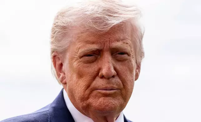 President Donald Trump speaks with reporters before departing on Marine One from the South Lawn of the White House, Wednesday, March 11, 2026, in Washington. (AP Photo/Alex Brandon)