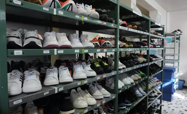 Used sneakers are stored in a room of SneakCoeurZ, a nonprofit organization giving used footwear a second life, in Champs-sur-Marne, east of Paris, Wednesday, March 25, 2026. (AP Photo/Thibault Camus)