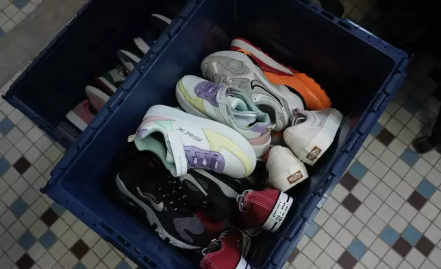 Salvaged sneakers for resale are stored in a bin at SneakCoeurZ, a nonprofit organization giving used footwear a second life, in Champs-sur-Marne, east of Paris, Wednesday, March 25, 2026. (AP Photo/Thibault Camus)
