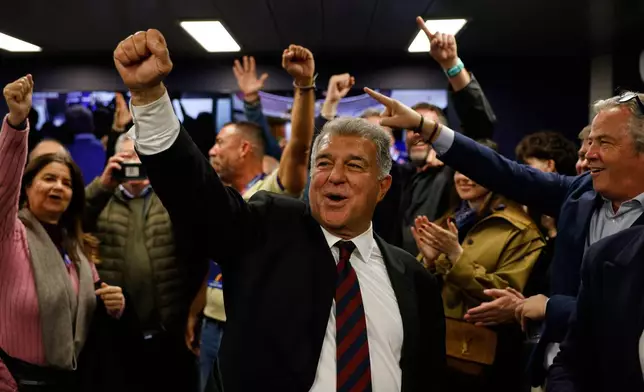 Candidate, Joan Laporta, center, reacts during early voting projections for the election to be president of FC Barcelona in Barcelona, Spain, Sunday, March 15, 2026. (AP Photo/Joan Monfort)