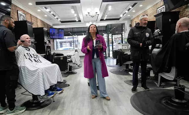 Analilia Mejia, the Democratic candidate running for New Jersey's 11th congressional district, talks to people at a barber shop in Morristown, N.J., Tuesday, March 24, 2026. (AP Photo/Seth Wenig)