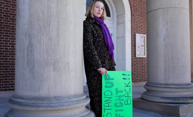 Allison Posner, an organizer for an upcoming "No Kings" protest poses for a photo on the steps of the town hall in Maplewood, N.J., Tuesday, March 24, 2026. (AP Photo/Seth Wenig)
