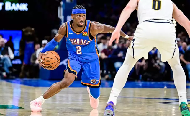 Oklahoma City Thunder guard Shai Gilgeous-Alexander (2) drives against Denver Nuggets guard Christian Braun (0) during the second half of an NBA basketball game Monday, March 9, 2026, in Oklahoma City. (AP Photo/Gerald Leong)