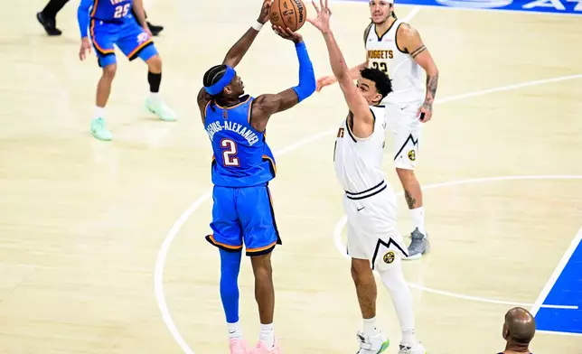 Oklahoma City Thunder guard Shai Gilgeous-Alexander (2) shoots against Denver Nuggets forward Spencer Jones (21) during the second half of an NBA basketball game Monday, March 9, 2026, in Oklahoma City. (AP Photo/Gerald Leong)