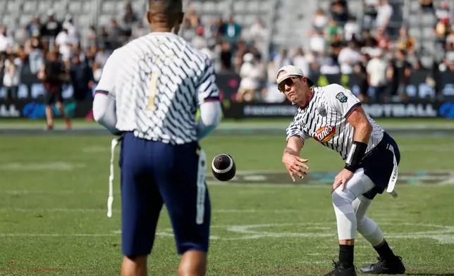 Founders FFC's Tom Brady tosses the ball to Founders FFC's Jalen Hurts against the Wildcats FFC during the Fanatics Flag Football Classic, Saturday, March 21, 2026, in Los Angeles. (AP Photo/Caroline Brehman)