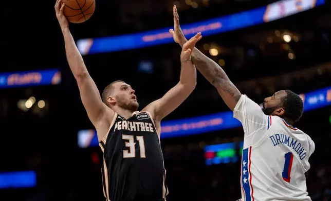 Atlanta Hawks center Jock Landale (31) attempts a basket against Philadelphia 76ers center Andre Drummond (1) during the first half of an NBA basketball game, Saturday, March 7, 2026, in Atlanta. (AP Photo/Erik Rank)