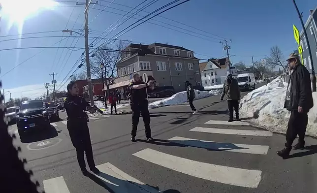 This photo taken from Hartford Police body camera video shows Steven Jones, right, as police officers shout commands to him seconds before he is shot by officer Joseph Magnano, center, Friday, Feb. 27, 2026 in Hartford, Conn. (Hartford Police Department via AP)