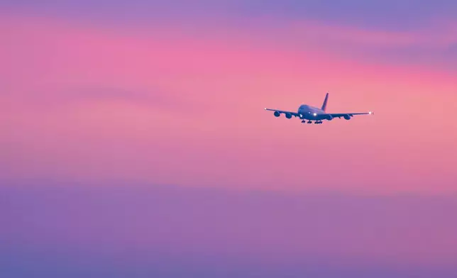 An Airbus A380 from Abu Dhabi lands without passengers, in Munich, Germany, Monday, March 2, 2026, due to safety reasons as a cabin crew of at least 17 people would have been required to take passengers on board, which, according to Lufthansa, was not available and could not be flown in due to the massive restrictions. (Malin Wunderlich/dpa via AP)