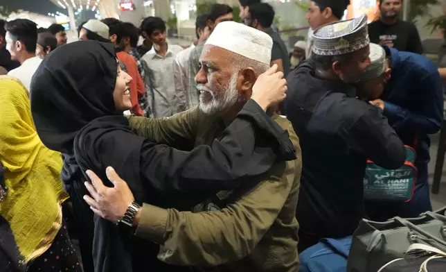 A man, center right, breaks down as he hugs a relative at airport upon his arrival from Jeddah, in Ahmedabad, India, Wednesday, March 4, 2026. (AP Photo/Ajit Solanki)
