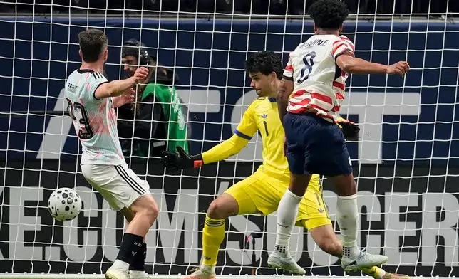 United States' Weston McKennie (8) scores past Belgium' goalkeeper Senne Lammens during the first half of an international friendly soccer match, Saturday, March 28, 2026, in Atlanta. (AP Photo/Mike Stewart)