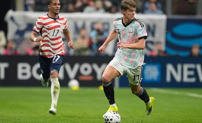Belgium's Charles De Ketelaere (17) dribbles ahead of United States' Malik Tillman (17) during an international friendly soccer match, Saturday, March 28, 2026, in Atlanta. (AP Photo/Mike Stewart)