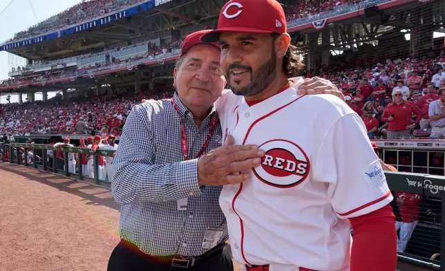 Former Cincinnati Reds player and Hall of Famer Johnny Bench, left, greets Cincinnati Reds' Eugenio Suárez before an opening-day baseball game against the Boston Red Sox in Cincinnati, Thursday, March 26, 2026. (AP Photo/Carolyn Kaster)