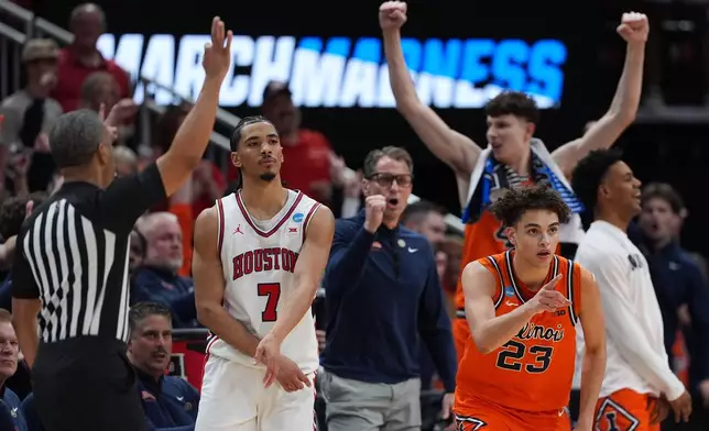 Illinois guard Keaton Wagler (23) reacts to a score alongside Houston guard Milos Uzan (7) during the second half against Houston in the Sweet 16 of the NCAA college basketball tournament Thursday, March 26, 2026, in Houston. (AP Photo/Eric Gay)