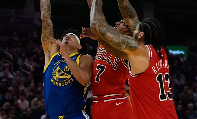 Golden State Warriors forward Gui Santos (15) shoots while defended by Chicago Bulls guard Rob Dillingham (7) during the first half of an NBA basketball game, Tuesday, March 10, 2026, in San Francisco. (AP Photo/Godofredo A. Vásquez)