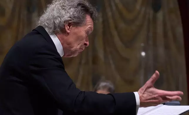 Harry Christopher conducts Angels Unawares byJames MacMillan in the Sistine Chapel at the Vatican, Sunday, March 22, 2026. (AP Photo/Domenico Stinellis)