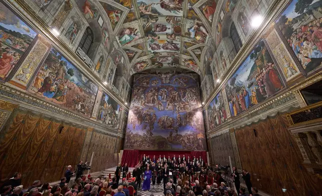 Conductor Harry Christopher, center, with tenor Matthew McKinney, left, soprano Elizabeth Watts, second from left, and The Sixteen present Angels Unawares byJames MacMillan in the Sistine Chapel at the Vatican, Sunday, March 22, 2026. (AP Photo/Domenico Stinellis)